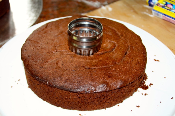 Cut out a small circle in the centre of each cake.